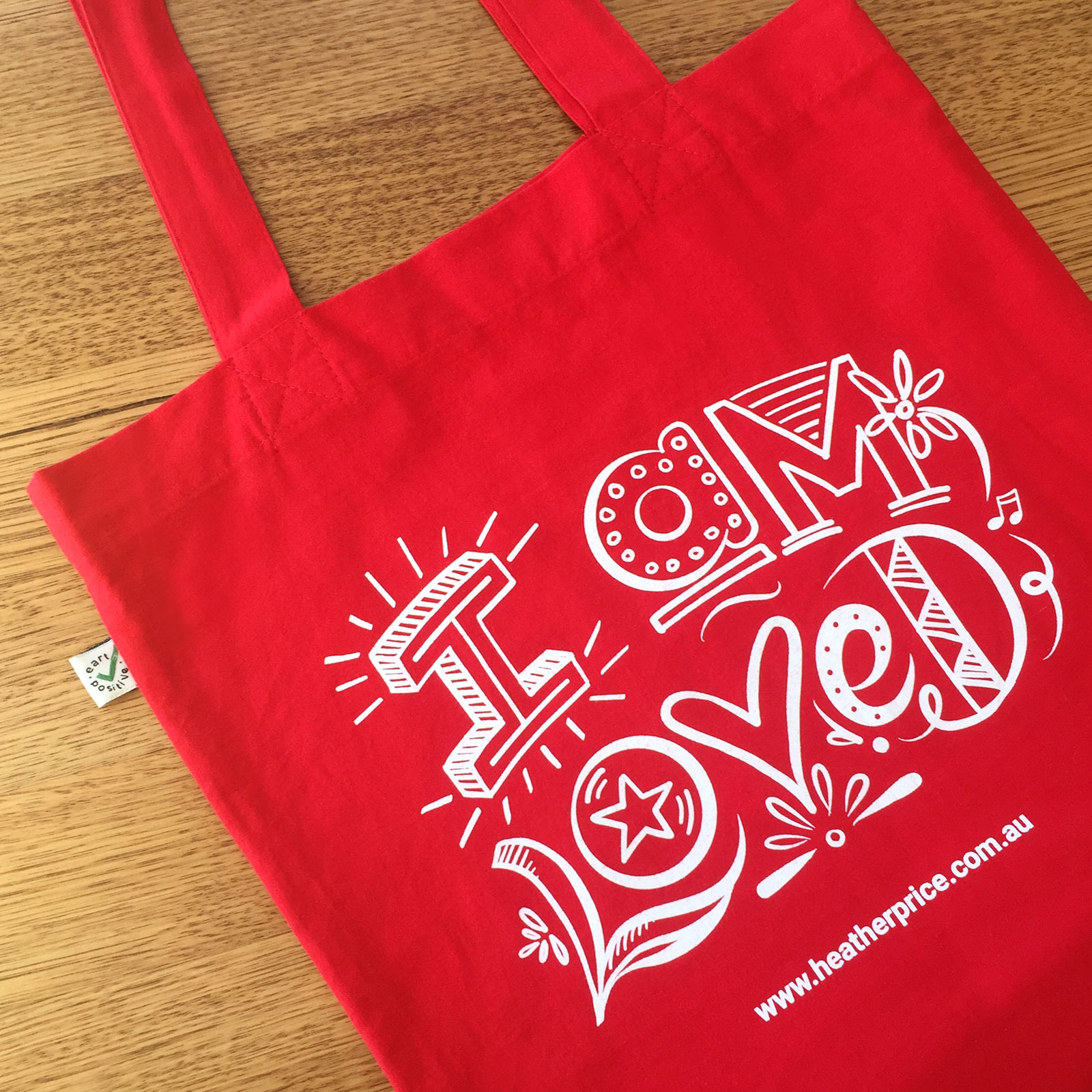 Screen printed album design tote bag with 'I am Loved' text design