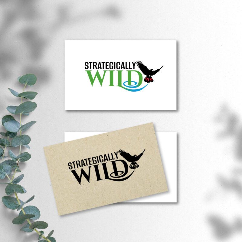Strategically Wild Business Cards on a table with plant branch and plant shadows.